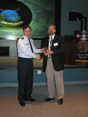 Tom Rachfalskim (l), chapter president, presents a token of appreciation to Maj. Gen. William T. Lord, USAF, commander, Air Force Cyber Command (Provisional), during the August luncheon.